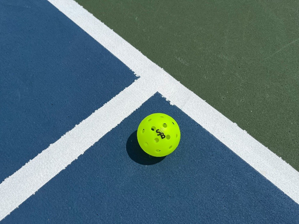 Featured image for “Are Indoor or Outdoor Pickleball Courts Better?”